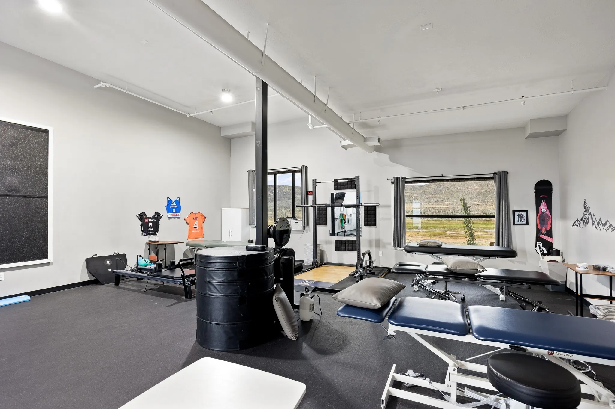 Spacious interior room with light grey walls and dark flooring