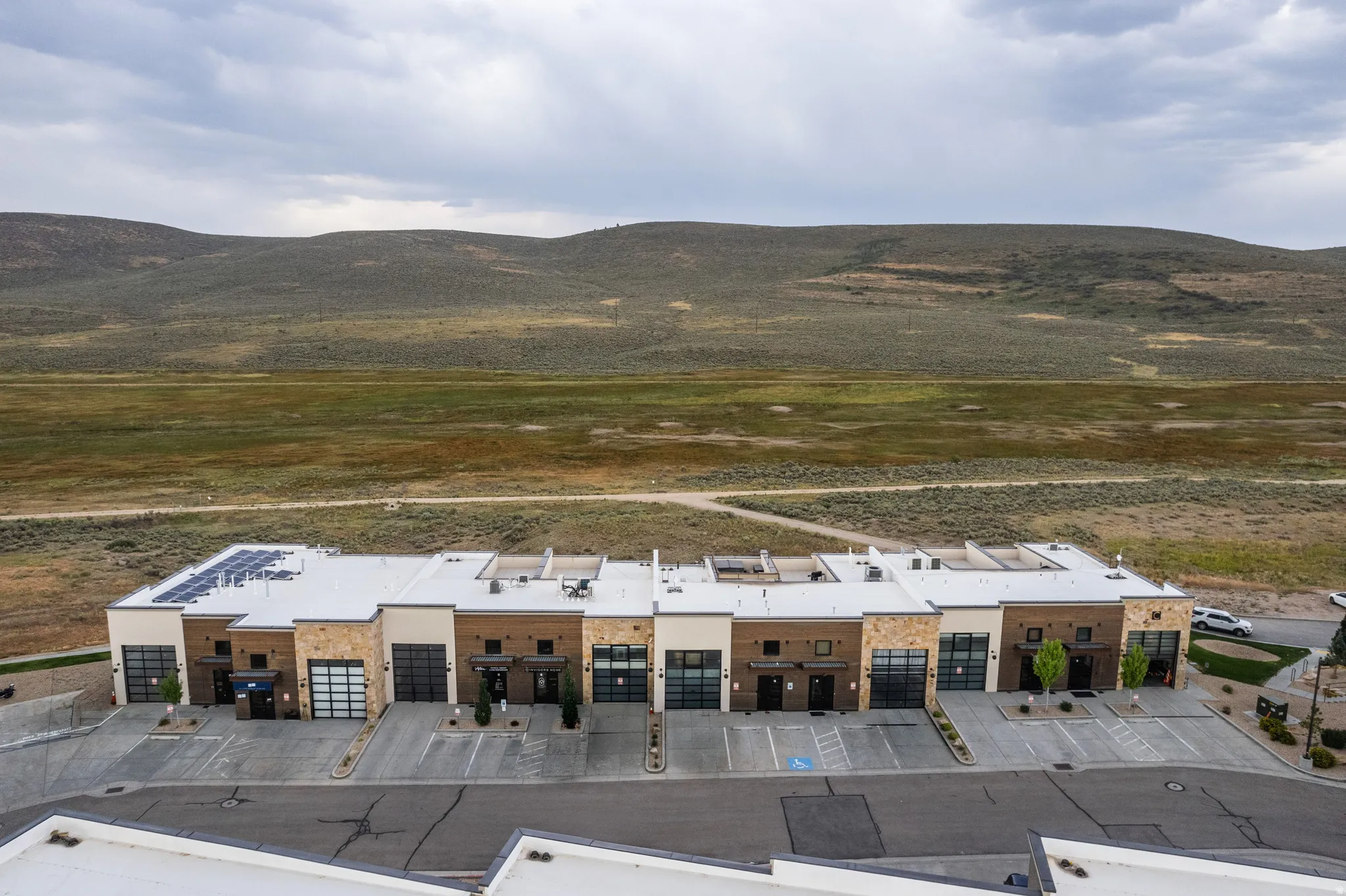 Contemporary townhome exteriors featuring varied stone and paneling finishes