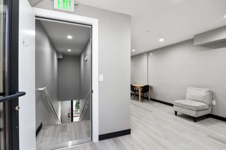 Interior hallway featuring light wood-finish flooring, recessed lighting, and a neutral wall color