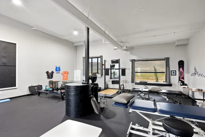 Spacious interior room with light grey walls and dark flooring