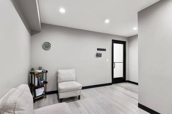 Entryway featuring a black-framed glass panel door, light wood-finish flooring, recessed lighting, and dark baseboards