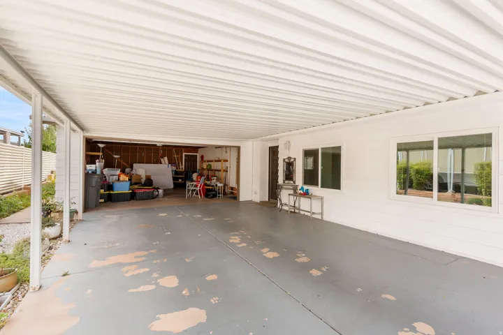 Spacious covered carport with an attached storage area