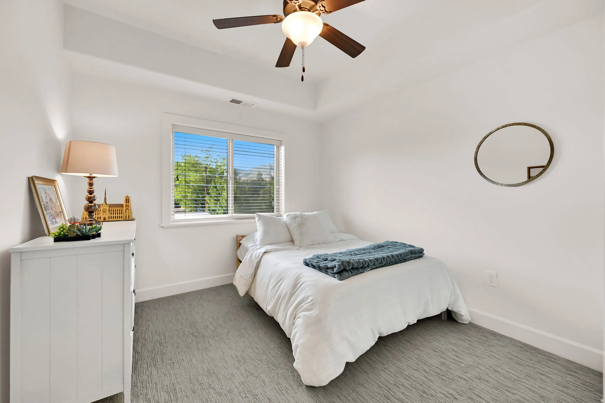 Bedroom featuring a tray ceiling and ceiling fan