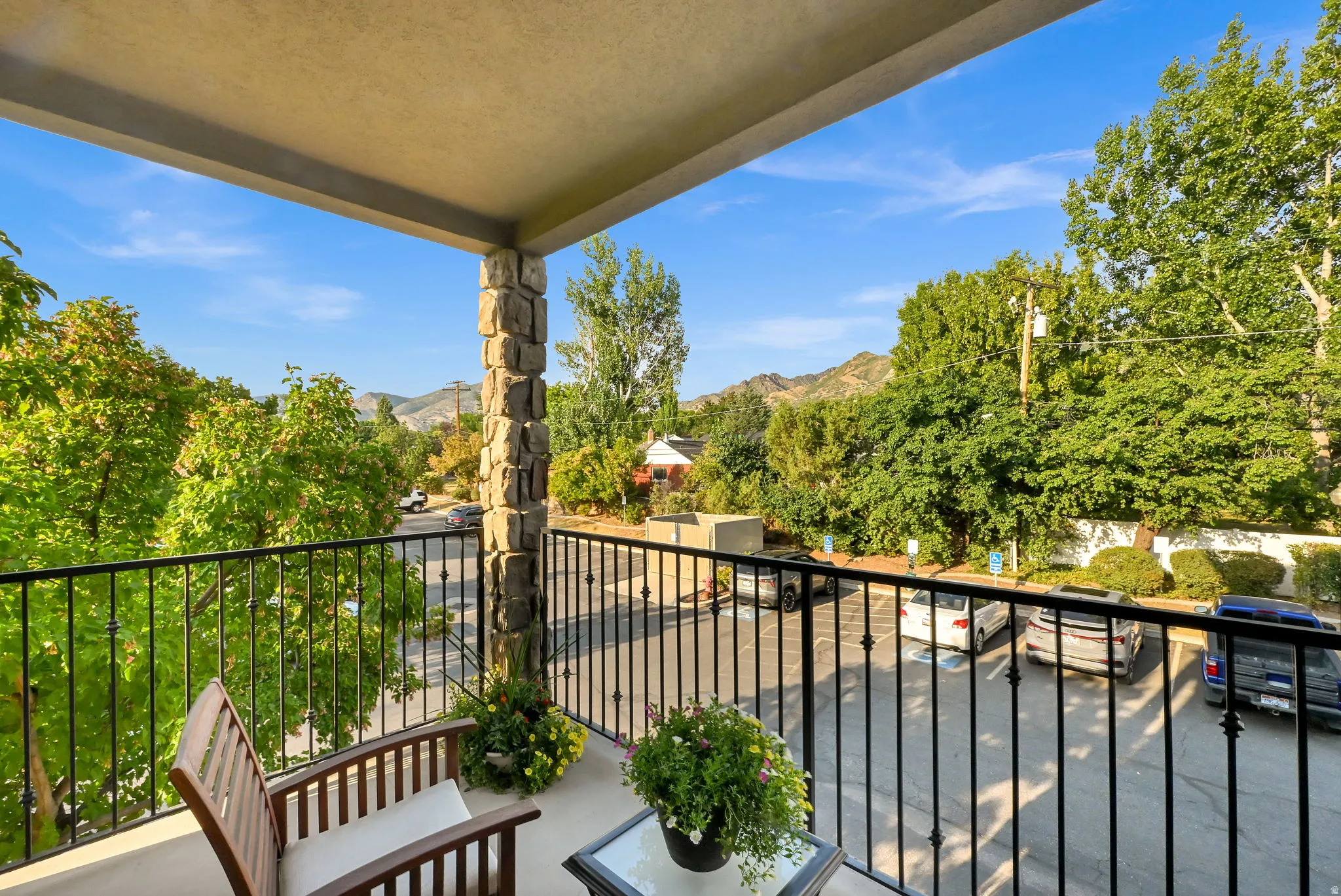 Private outdoor balcony featuring trees and mountain views