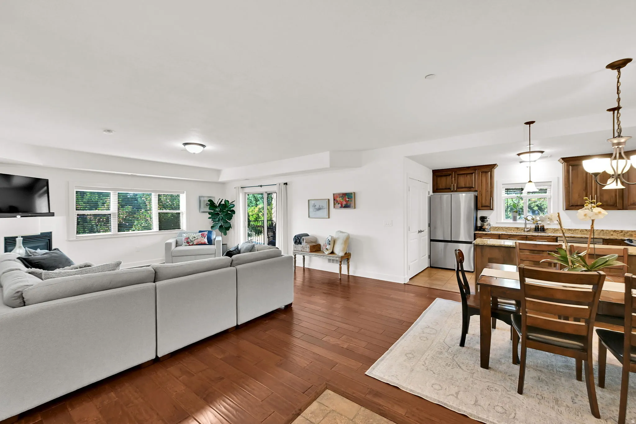 Open-concept living space featuring wood-finish flooring, recessed lighting, and white walls