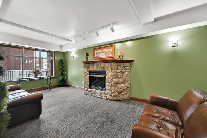 Lobby on Level M: 100 (Main) with Stone fireplace featuring a wood mantel