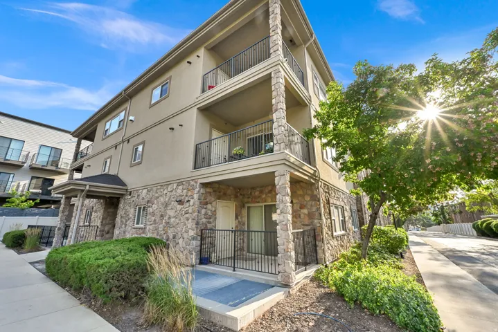 Corner Unit on 2nd Floor: Multi-level building with stone veneer lower facade and stucco upper levels