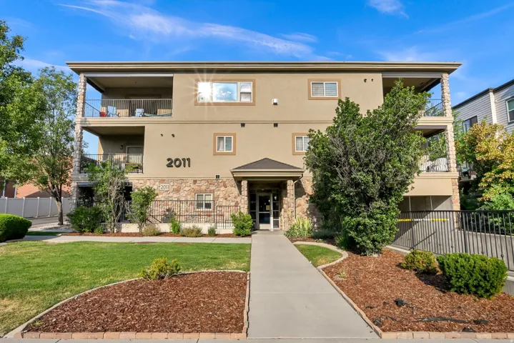 Multi-story building featuring a stucco exterior with stone accents and multiple private balconies