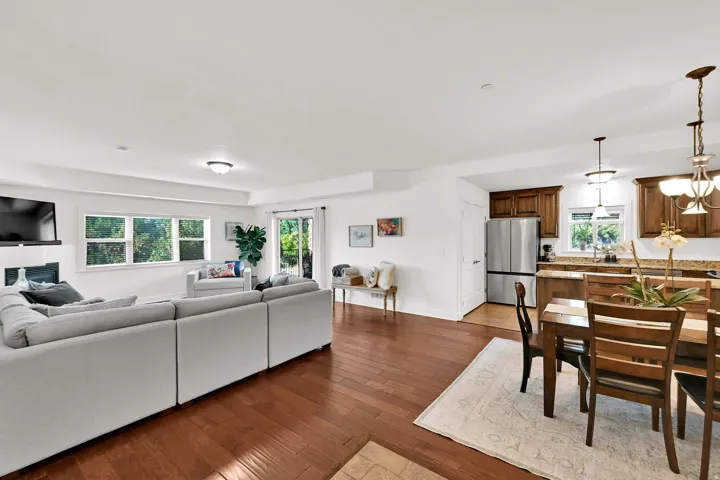 Open-concept living space featuring wood-finish flooring, recessed lighting, and white walls