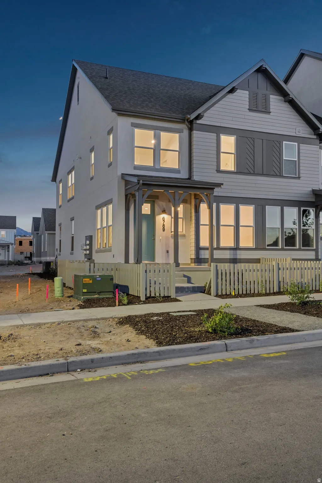 Contemporary two-story residence featuring a covered front porch with decorative wood accents