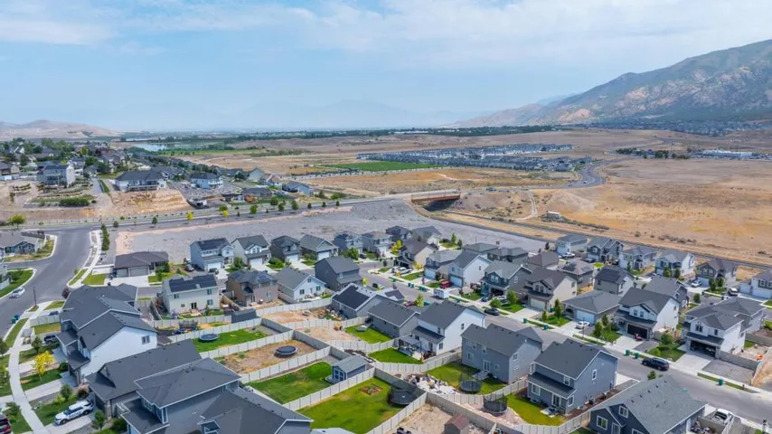 Aerial perspective showcasing a residential community with varied home styles and grey roofing