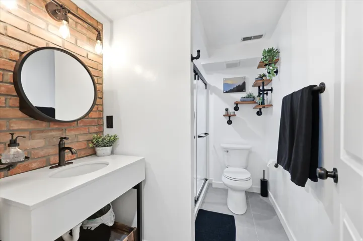 Bathroom featuring a floating vanity with a white countertop and integrated sink