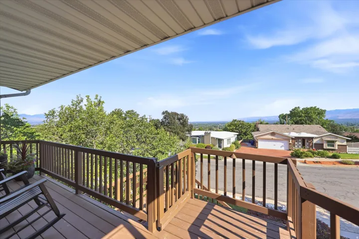 Expansive outdoor deck featuring wood-finish railing, composite decking, and an overhead awning