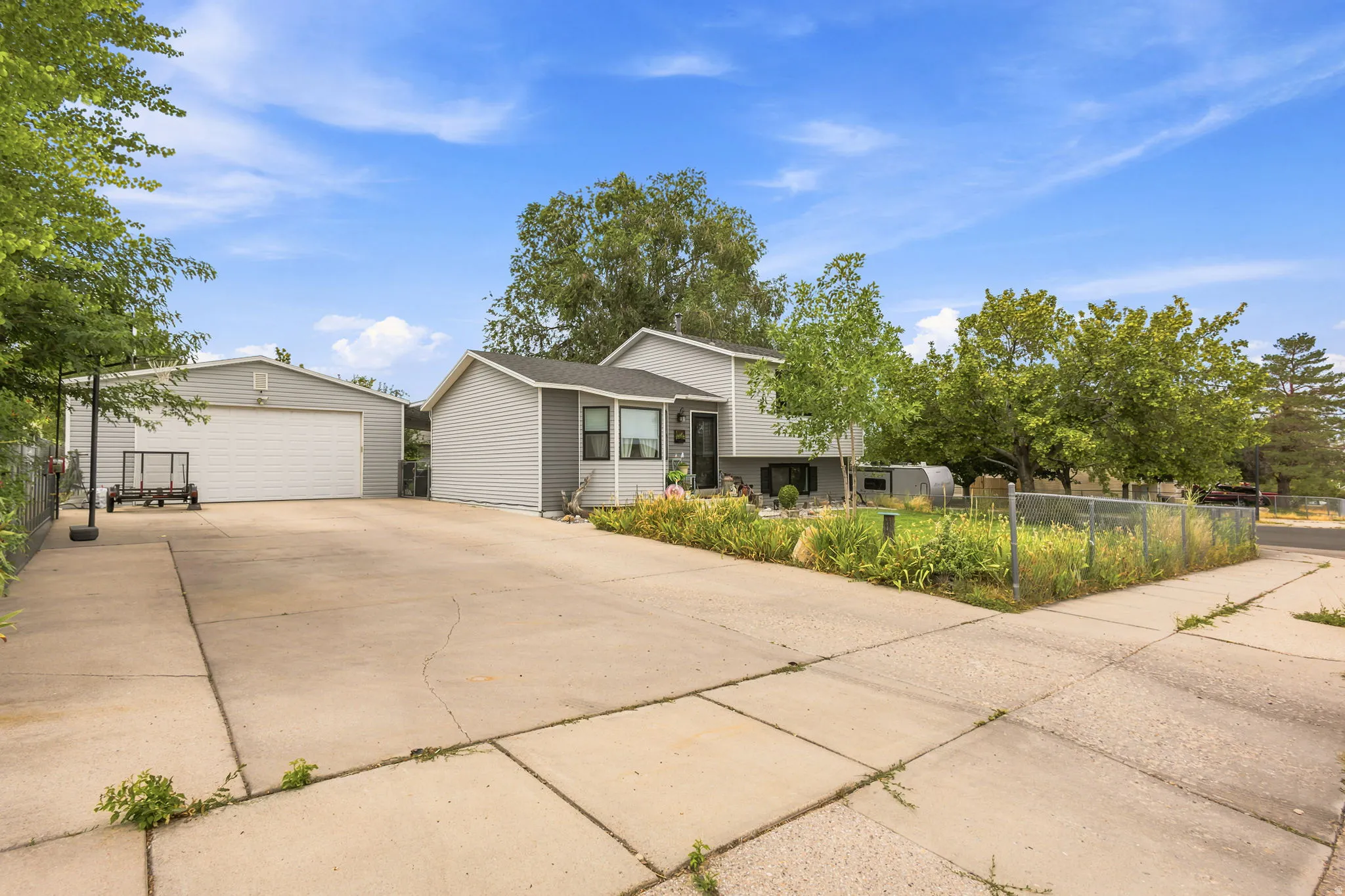 Property exterior featuring a gray siding facade and a sizable driveway