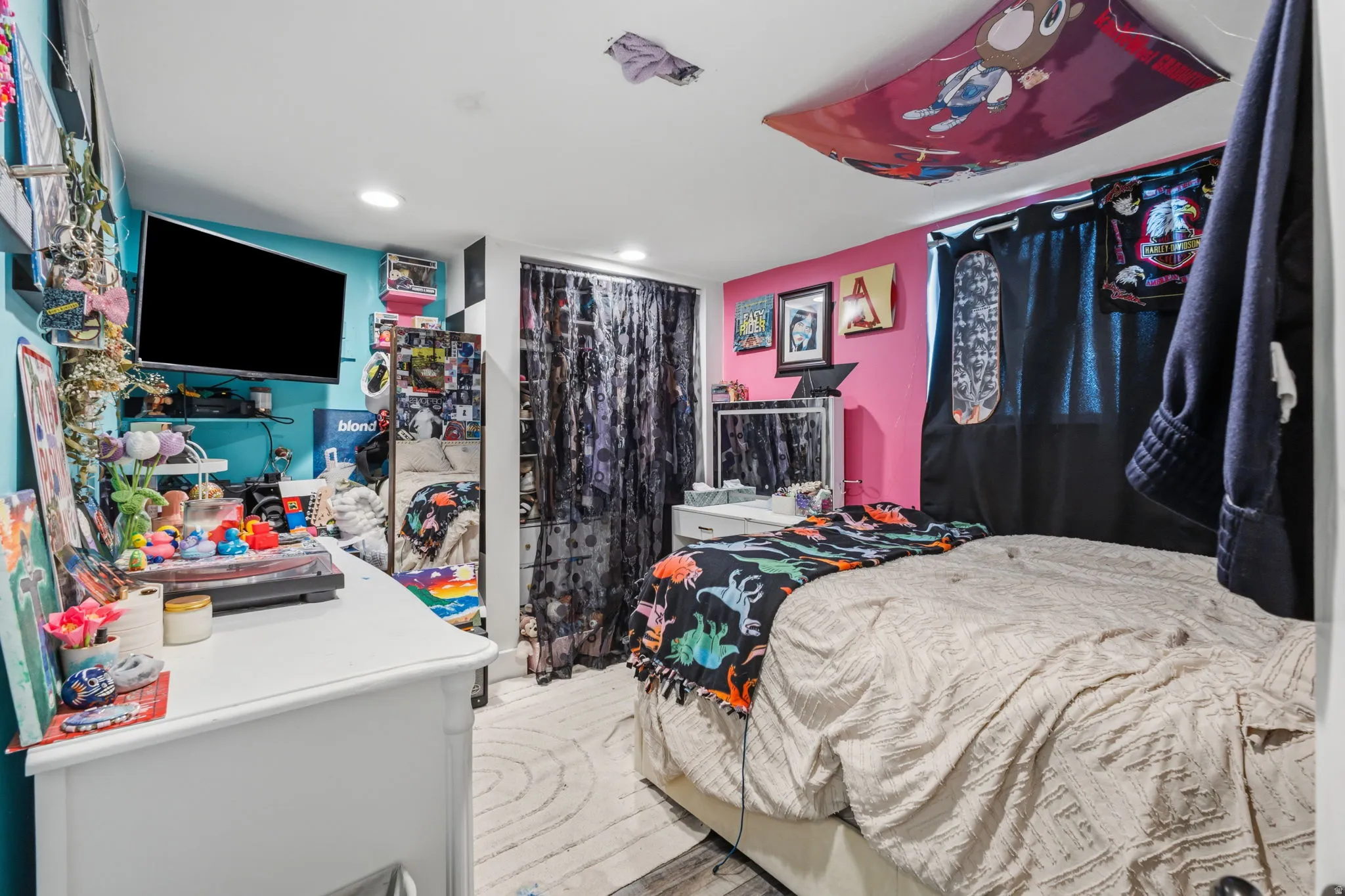 Room featuring two-tone wall paint, recessed lighting, and wood-finish flooring