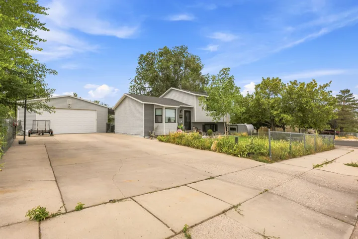 Property exterior featuring a gray siding facade and a sizable driveway