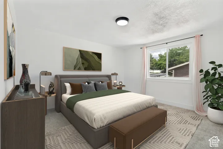 Bright bedroom featuring a large window, white walls, textured carpeting, and a flush-mount ceiling light