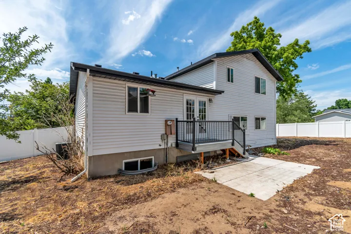 Rear exterior a wooden deck with black railings. The backyard is a black canvas to create your own oasis!