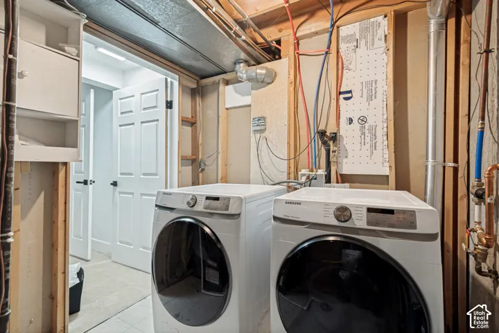 Dedicated utility space featuring exposed framing and a visible plumbing system