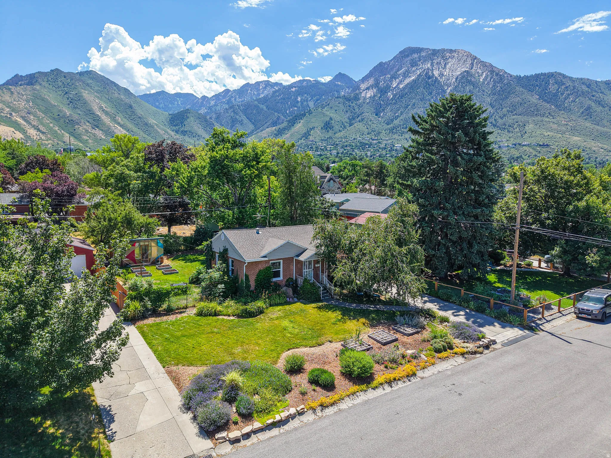 Brick ranch-style residence featuring a prominent mountain backdrop