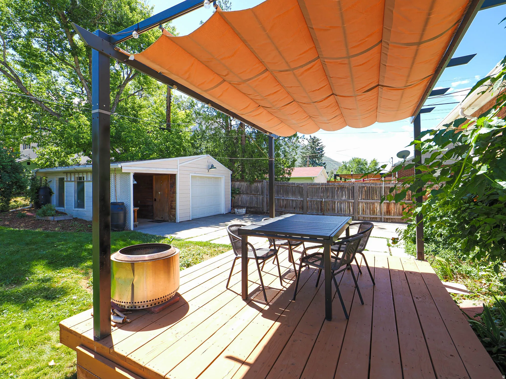 Expansive wood deck with a retractable fabric canopy
