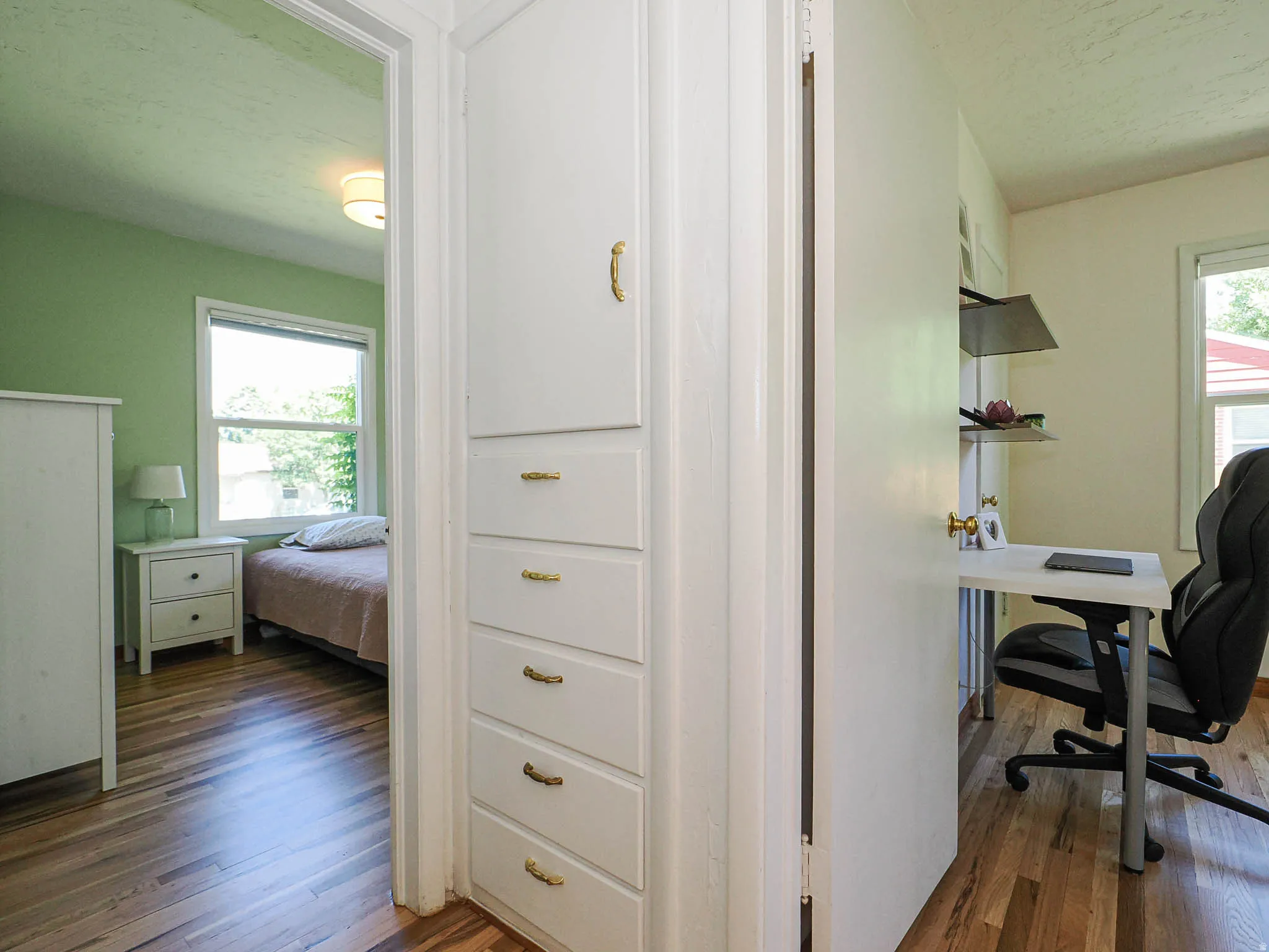 Hallway built-in storage with multiple drawers and upper cabinet