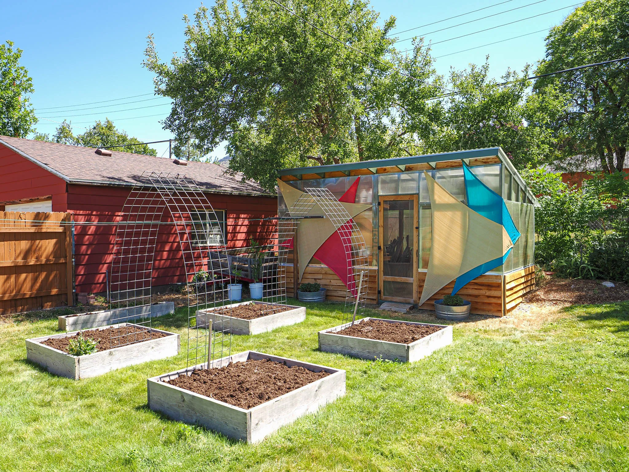 Greenhouse structure featuring translucent panels and a wooden base