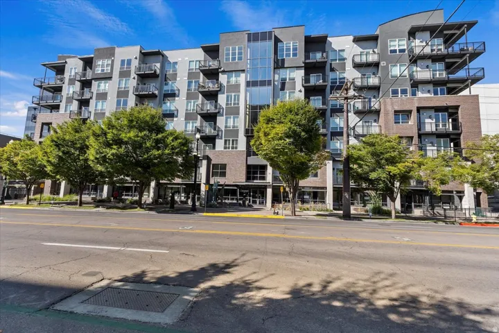 Contemporary multi-story building featuring a facade of mixed materials including brick, glass, and paneling