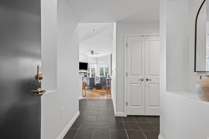 Entryway featuring dark square tile flooring