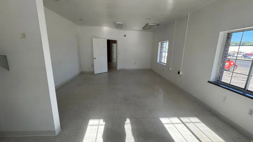 Open concept space featuring tile flooring and white painted walls