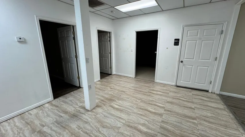 Open commercial space featuring light-toned wood-finish flooring