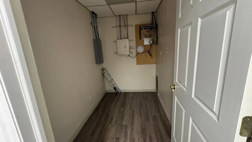 Room featuring wood-finish flooring and neutral wall tones
