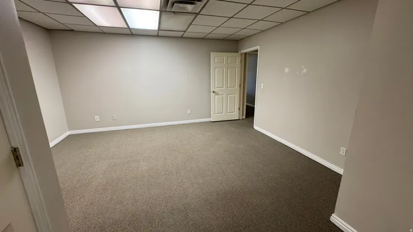 Neutral-toned carpeting paired with light beige walls and white trim