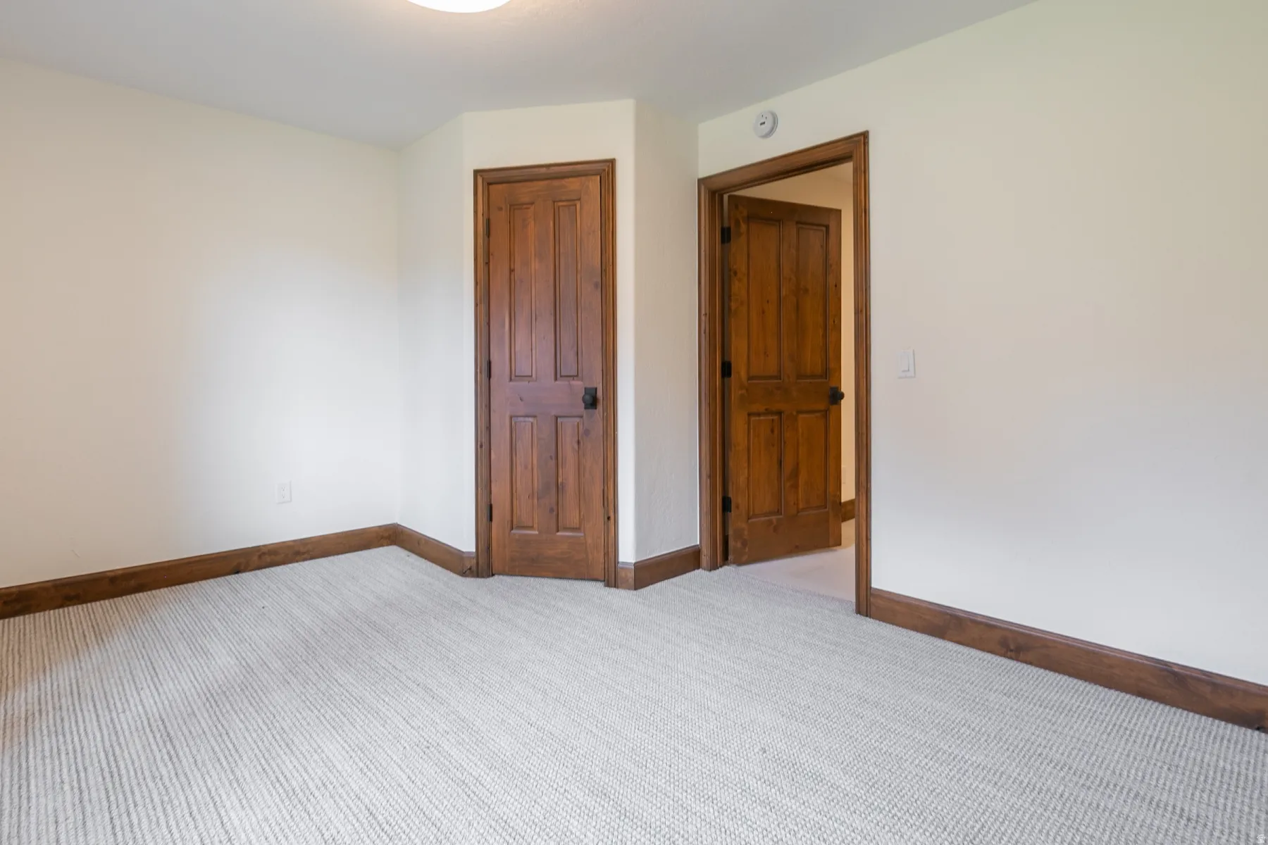 Neutral tone walls with coordinating striped carpeting