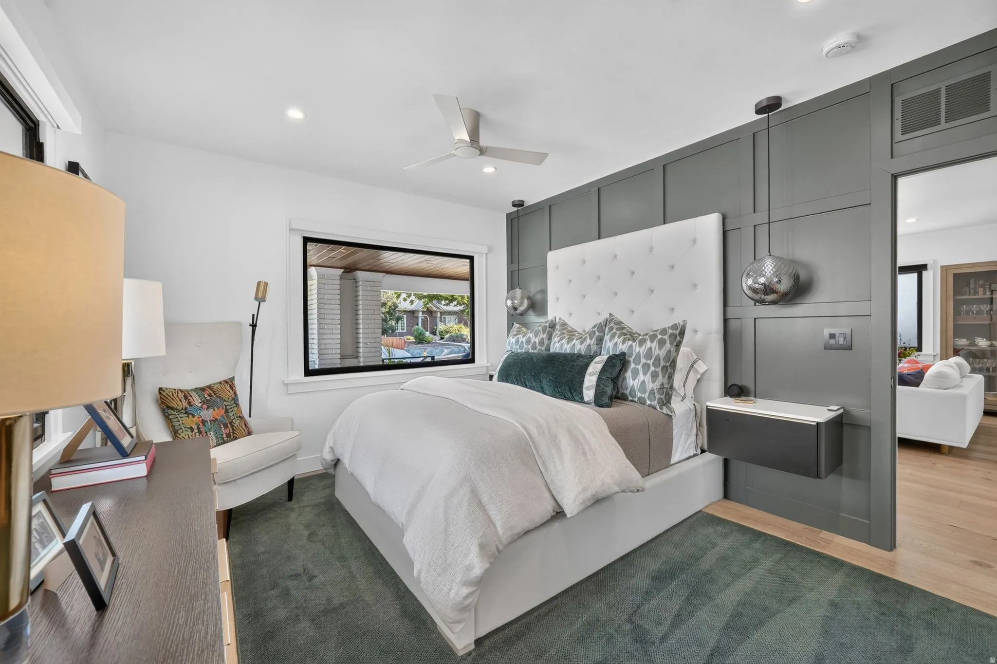 Primary bedroom.  Board and batten accent wall, custom night stands with integrated automated push button controls, and custom pendants lights above.