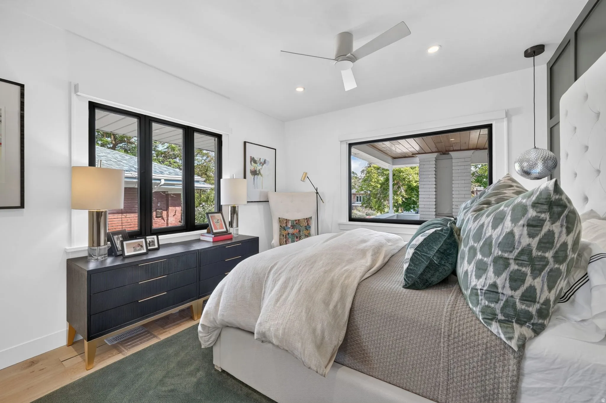 Main floor primary bedroom and retreat.  Ample natural light, custom motorized dual-direction shades, white oak hardwood flooring.