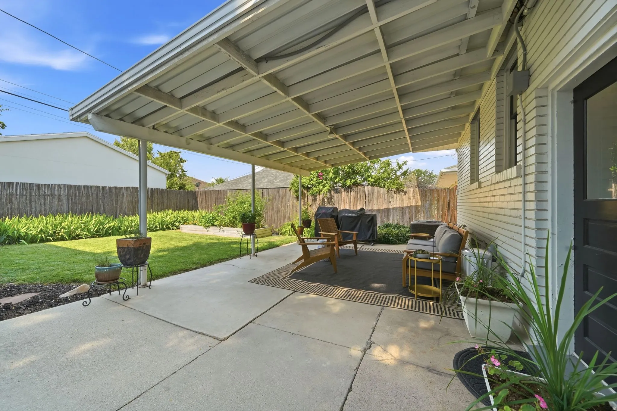 Covered patio off back door.  Well maintain back yard, full sprinkler & drip system, raised garden boxes,  and manicured flower beds.