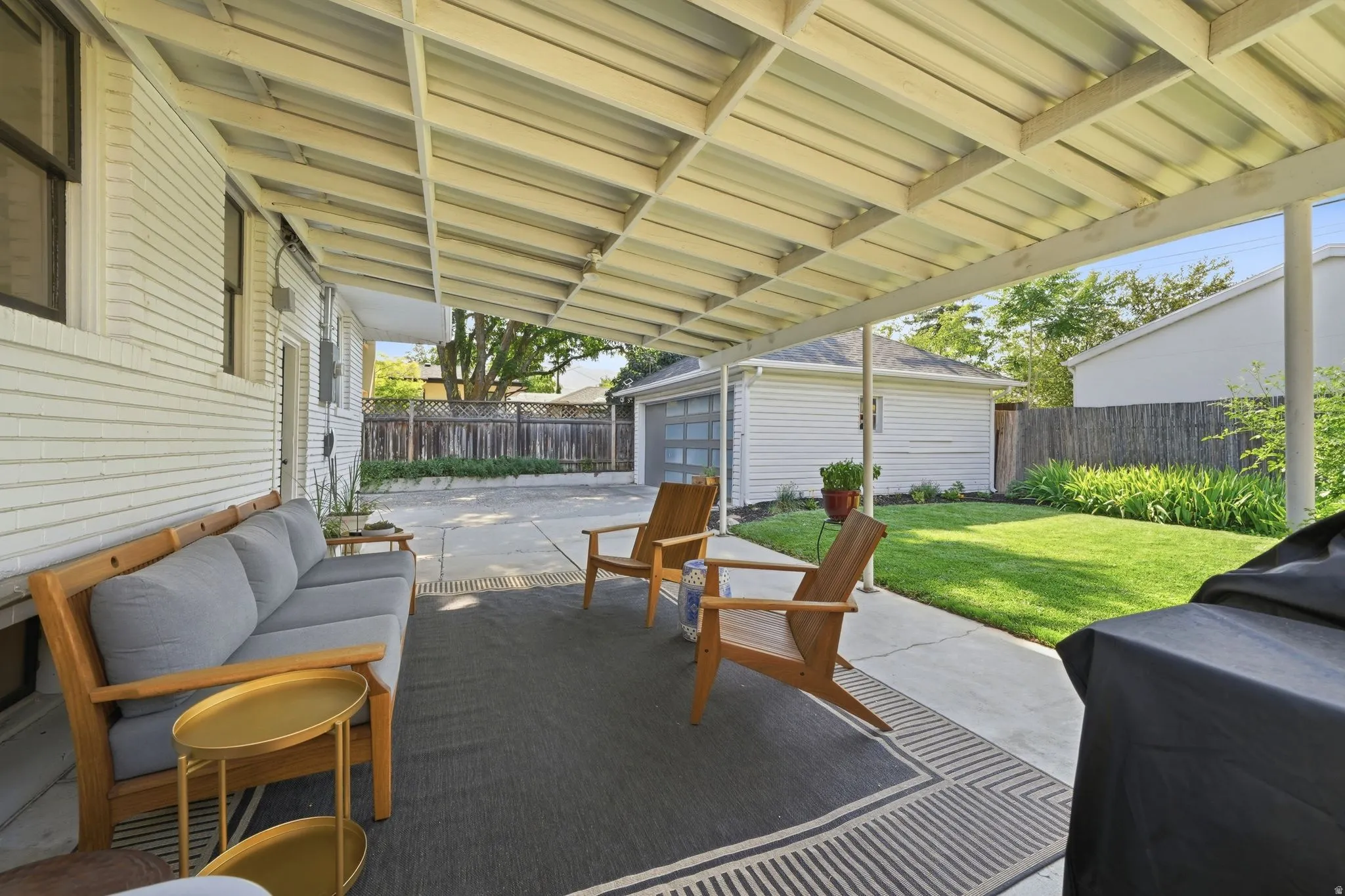 Covered patio, well manicured back yard, 2 car garage, and EV car charger.