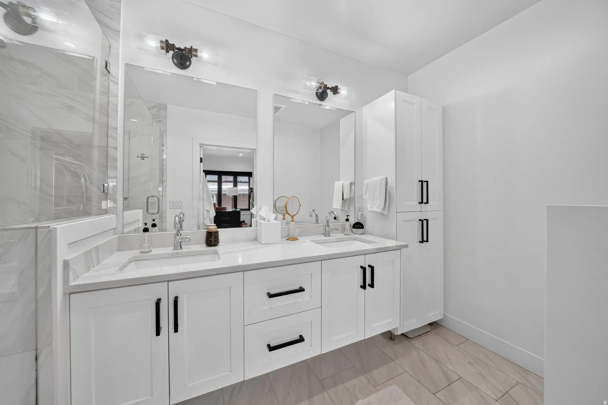 Primary bathroom retreat.  Dual vanity, quartz countertops, spa walk-in shower with euro glass enclosure, and custom linen cabinet.