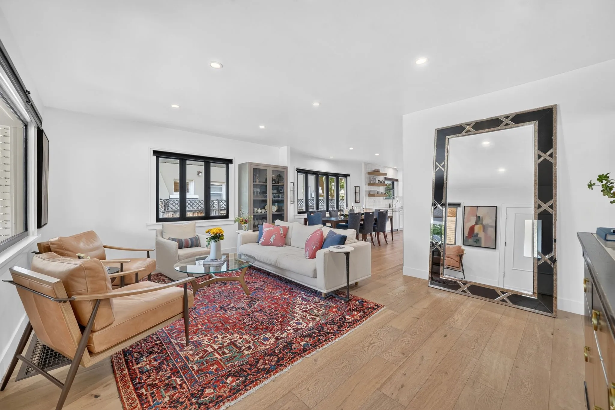 Spacious entry & living area featuring solid white oak hardwood flooring throughout, recessed lighting, and expansive black trim windows.