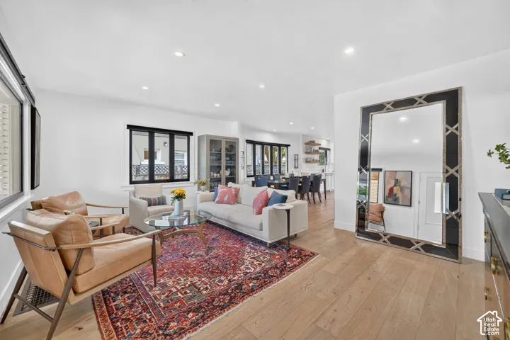 Spacious entry & living area featuring solid white oak hardwood flooring throughout, recessed lighting, and expansive black trim windows.