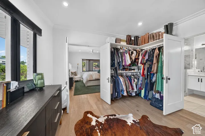 Expansive custom walk-in closet and primary bathroom.  Natural light pouring in, dual-direction custom window coverings, AND hook ups in closet for stackable washer & dryer.