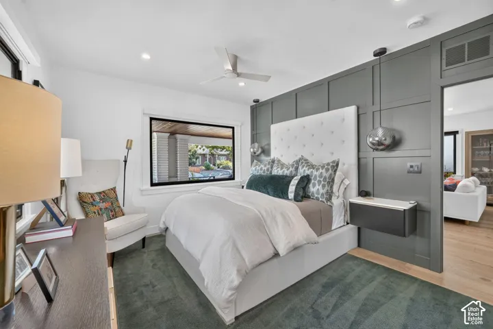 Primary bedroom.  Board and batten accent wall, custom night stands with integrated automated push button controls, and custom pendants lights above.
