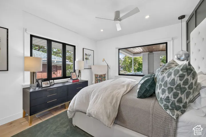 Main floor primary bedroom and retreat.  Ample natural light, custom motorized dual-direction shades, white oak hardwood flooring.