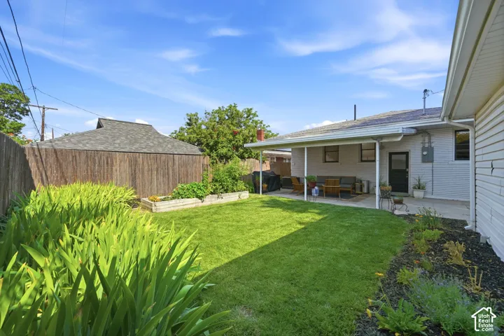 Well maintain back yard, full sprinkler & drip system, raised garden boxes, manicured flower beds, bamboo privacy fence, and covered patio.