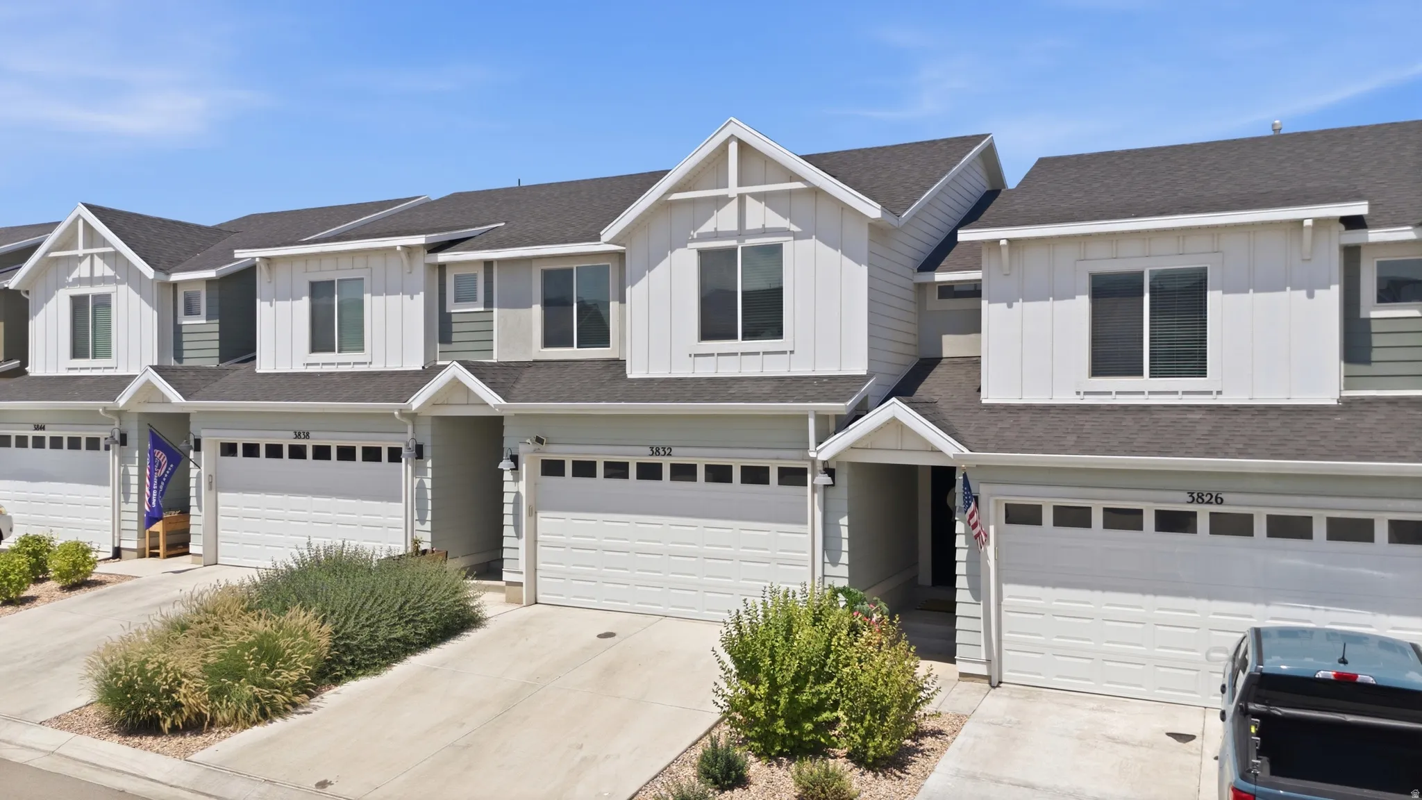 Modern townhome exteriors featuring vertical and horizontal siding