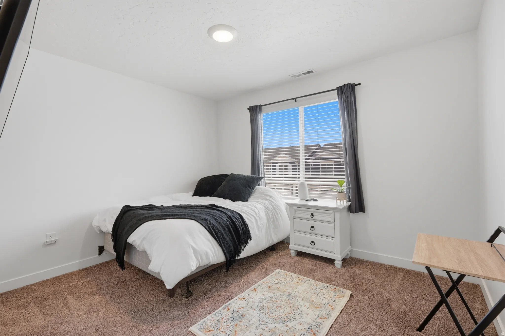 Bedroom featuring recessed lighting, a single window with blinds and drapes, and neutral-toned carpet flooring