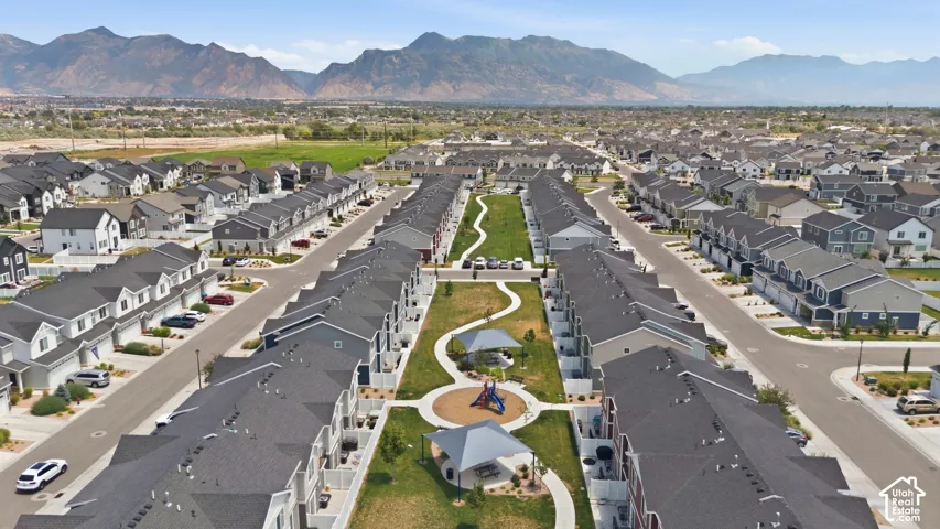Community green space with walking paths, playground structures, and shade canopies