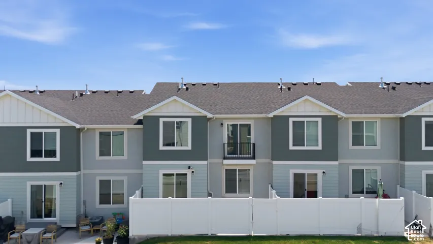Modern townhome exteriors featuring multi-toned siding, gabled rooflines, and private patios