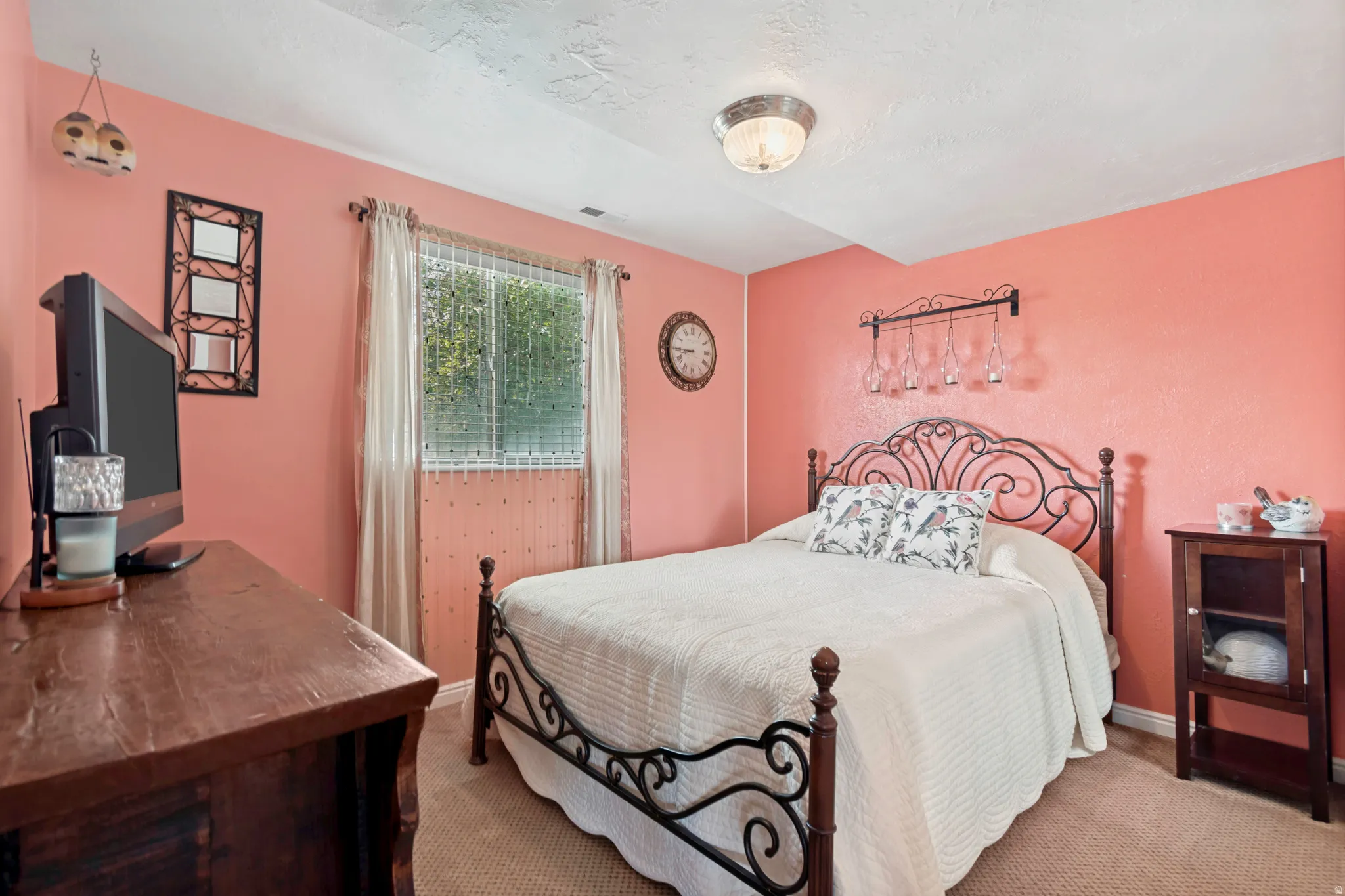 Bedroom featuring a window with blinds, overhead lighting, and carpet flooring